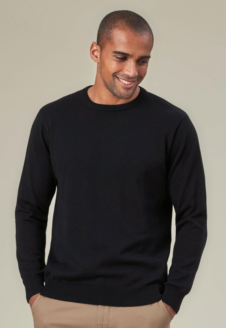 Model wearing the Jackson Crew Neck Jumper in black with beige trousers
